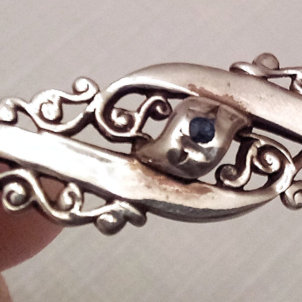 silver pin with small sapphire